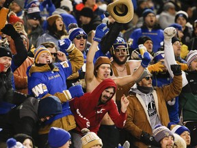 Winnipeg Blue Bombers' fans celebrate the win over the B.C. Lions in the CFL West final in Winnipeg, Sunday, Nov. 13, 2022.