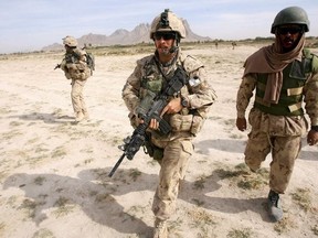 Panjwayi, AFGHANISTAN: Canadian soldiers from the Royal 22nd Regiment, who worked with the Afghan National Army (ANA) as an "Observer Mentor Liasion Training" (OMLT) team, conduct a foot patrol in a volatile area in Panjwayi district, Kandahar province, Nov. 8, 2006.