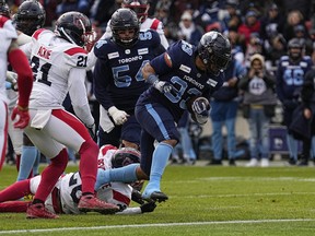 Argonauts running back Andrew Harris (33) scores a touchdown against the Montreal Alouettes during the first half at BMO Field.