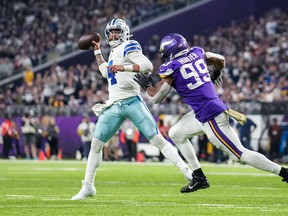 Dallas Cowboys quarterback Dak Prescott (4) throws over Minnesota Vikings linebacker Danielle Hunter (99) during the third quarter at U.S. Bank Stadium.