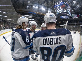 Winnipeg Jets left wing Kyle Connor (81) and left wing Pierre-Luc Dubois (80) and defenceman Josh Morrissey (44) celebrates a goal scored by Connor against the Dallas Stars during the third period at the American Airlines Center in Dallas on Friday, Nov. 25, 2022.