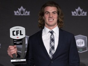 Rookie of the year, wide receiver Dalton Schoen of the Winnipeg Blue Bombers, holds up his trophy during the CFL Awards in Regina. Paul Chiasson/THE CANADIAN PRESS