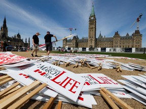 In this May photo, anti-abortion campaigners prepare for the annual National March for Life at the grounds of Parliament Hill.