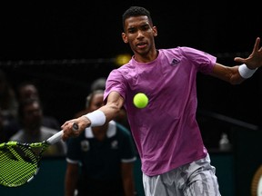 Montreal's Félix Auger-Aliassime plays a forehand return during the men's singles semifinal tennis match against Denmark's Holger Rune on Day 6 of the ATP World Tour Masters 1000 in Paris, November 5, 2022.