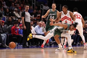 Scottie Barnes of the Raptors knocks the ball away from Jaden Ivey of the Pistons during the first half at Little Caesars Arena in Detroit on Monday, Nov. 14, 2022.