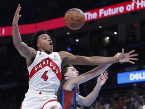 Toronto Raptors forward Scottie Barnes and Oklahoma City Thunder guard Josh Giddey fight for a rebound during the first quarter at Paycom Center.
