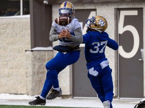 Winnipeg Blue Bombers Nic Demski (left) and Brandon Alexander fight for a jump ball in the end zone during practice at Leibel Field on Friday, Nov. 18, 2022 in Regina.