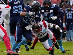 Toronto Argonauts running back Andrew Harris (33) avoids a tackle from Montreal Alouettes linebacker Tyrice Beverette (26) to score a touchdown during the first half at BMO Field in Toronto on Nov. 13, 2022.