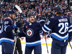 Winnipeg Jets defenceman Dylan DeMelo (2) and right wing Blake Wheeler (26) celebrate the second period goal by Winnipeg Jets left wing Pierre-Luc Dubois (80) against the Dallas Stars at Canada Life Centre in Winnipeg on Nov. 8, 2022.