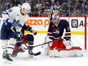 Winnipeg Jets goaltender Connor Hellebuyck (37) blocks a shot by Toronto Maple Leafs left wing Michael Bunting (58) in the first period at Canada Life Centre in Winnipeg on Oct. 22, 2022.