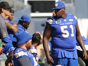 Winnipeg Blue Bombers offensive lineman Jermarcus Hardrick (right) keeps things light at the bench during the walkthrough, ahead of its game against Calgary, on Wed., Aug. 24, 2022.
