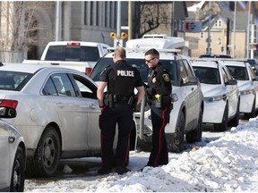 Police officers talk outside a duplex in the 400 block of William Avenue in Winnipeg on Monday, Nov. 14, 2022. A 23-year-old woman, Delaney Nora Desmarais, was shot and killed on William Avenue on Nov. 12.