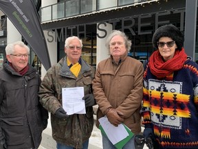 (Left to right) Norm Pohl, Gerald Brown, Tom Simms and Karin Gordon of the Lions Place Residents Council Seniors Action Committee stand in front of the Smith Street Lofts in downtown Winnipeg on Tuesday, Nov. 29, 2022, with Brown holding a notice Lions Place tenants received Friday. The seniors are concerned after learning that Lions Housing Centre had sold Lions Place on Portage Avenue to an Alberta firm and that Lions Place will face a similar fate to the social housing building which was sold to a private developer for Smith Street Lofts with rent being doubled making it unaffordable for low and-fixed-income residents.