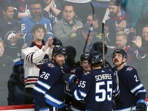 Winnipeg Jets forward Blake Wheeler (left) celebrate his goal with Mark Scheifele, Cole Perfetti, and Dylan DeMelo (from left) against the Colorado Avalanche in Winnipeg on Tuesday, Nov. 29, 2022.