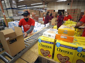 Food hampers are assembled at the new location of the Christmas Cheer Board on Wellington Avenue in Winnipeg on Tuesday, Nov. 15, 2022.