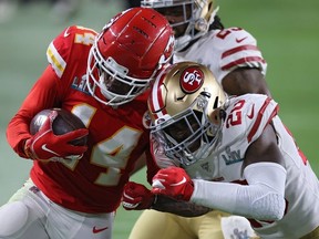 Sammy Watkins of the Kansas City Chiefs is tackled by Jimmie Ward of the San Francisco 49ers Super Bowl LIV at Hard Rock Stadium on February 02, 2020 in Miami, Florida.