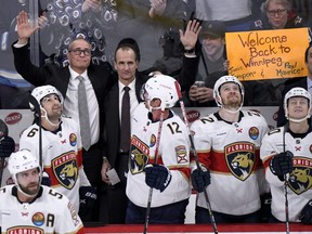 Florida Panthers’ head coach Paul Maurice (left) and assistant coach Jamie Kompon wave to fans during a break in the action against the Winnipeg Jets during first period NHL action in Winnipeg on Dec. 6, 2022. Maurice and Kompon previously coached the Winnipeg Jets.