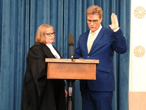 Former Winnipeg city councillor Kevin Klein, right, is officially sworn in as the MLA for Kirkfield Park on Friday, Dec. 23.