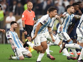Lionel Messi and Argentina players celebrate after the team's victory through the penalty shootout in the FIFA World Cup Qatar 2022 Final match between Argentina and France at Lusail Stadium on December 18, 2022 in Lusail City, Qatar.