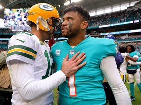 Aaron Rodgers #12 of the Green Bay Packers hugs Tua Tagovailoa #1 of the Miami Dolphins on the field after the game at Hard Rock Stadium on December 25, 2022 in Miami Gardens, Florida.