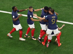 Theo Hernandez of France celebrates with teammates after scoring the team's first goal against Morocco.