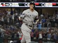New York Yankees' Aaron Judge gestures as he runs the bases after hitting a solo home run, his 62nd of the season, during the first inning in the second baseball game of a doubleheader against the Texas Rangers in Arlington, Texas, Tuesday, Oct. 4, 2022.