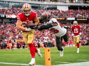 49ers running back Christian McCaffrey (23) scores a touchdown against Tampa Bay Buccaneers safety Logan Ryan on Sunday.