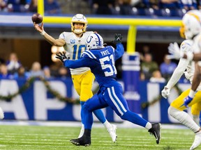 Los Angeles Chargers quarterback Justin Herbert (10) passes the ball while Indianapolis Colts defensive end Kwity Paye (51) defends in the second half at Lucas Oil Stadiumon Dec 26, 2022 in Indianapolis.
