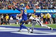 Los Angeles Rams tight end Tyler Higbee (89) scores on a 7-yard touchdown reception against Denver Broncos cornerback Damarri Mathis (27) in the first half at SoFi Stadium Dec 25, 2022.