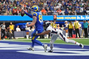 Los Angeles Rams tight end Tyler Higbee (89) scores on a 7-yard touchdown reception against Denver Broncos cornerback Damarri Mathis (27) in the first half at SoFi Stadium Dec 25, 2022.