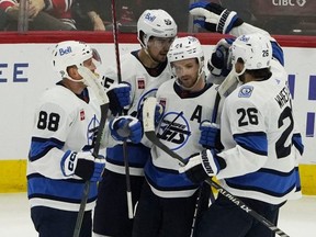 Josh Morrissey (44) and teammates from the Winnipeg Jets celebrate a goal against the Chicago Blackhawks in the first half at the United Center in Chicago on Friday, December 9, 2022.