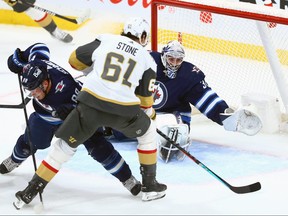 Vegas Golden Knights forward Mark Stone (61) puts a loose puck past Winnipeg Jets goaltender Connor Hellebuyck at Canada Life Centre on Tuesday.
