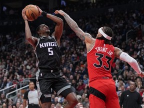 Kings guard De'Aaron Fox (left) drives to the basket as Raptors guard Gary Trent Jr. (right) tries to defend during second quarter NBA action at Scotiabank Arena in Toronto, Wednesday, Dec 14, 2022.