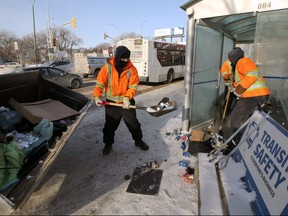 Winnipeg Transit employees clean out a bus shelter with help from a loader on Osborne Street in Winnipeg on Tues., Feb. 9, 2021. Kevin King/Winnipeg Sun/Postmedia Network