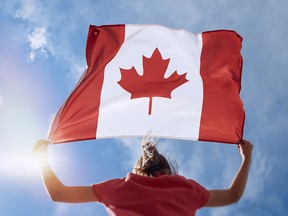 Teen is waving Canadian flag