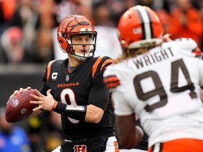 Cincinnati Bengals quarterback Joe Burrow looks to throw under pressure in the second quarter during a Week 14 NFL game against the Cleveland Browns at Paycor Stadium.