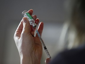 A vaccine is drawn at a clinic in Winnipeg, Friday, March 19, 2021.The Manitoba Labour Board has dismissed several complaints from workers who wanted their unions to fight COVID-19 requirements.THE CANADIAN PRESS/John Woods