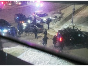 A submitted photo of Winnipeg police near a BMW after an officer-involved shooting on Portage Avenue at Bourkevale Drive in the evening of Dec. 3, 2022.  Submitted photo