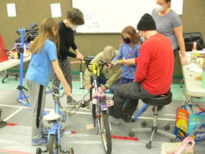 (Left to right) Eliott Baxter, Terry Wiens, Les Wiens, Tessa Baxter, Colin Baxter and Dana Baxter volunteer at the 12th annual WRENCH (Winnipeg Repair Education and Cycling Hub) 24-hour kids bike repair marathon called The Cycle of Giving, at the Lord Roberts Community Club in Winnipeg on Saturday, Dec. 10, 2022.