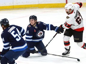 Winnipeg Jets defenceman Ville Heinola (centre) is in a compromising position while defending an Ottawa Senators 2-on-1 with Rourke Chartier shooting in Winnipeg on Tuesday, Dec. 20, 2022.
