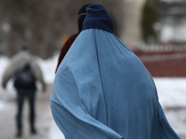 A person wears a touque while walking in Winnipeg on Wednesday, March 30, 2022.