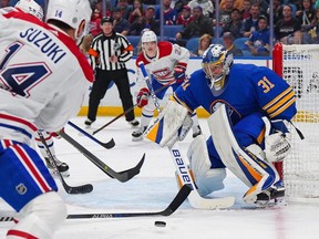 Eric Comrie (31) of the Buffalo Sabres makes the save against Nick Suzuki (14) of the Montreal Canadiens during the third period at KeyBank Center on Oct. 27, 2022 in Buffalo.