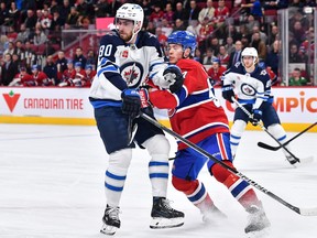 Pierre-Luc Dubois (80) of the Winnipeg Jets and Jordan Harris (54) of the Montreal Canadiens skate against each other during the first period at Centre Bell on Jan. 17, 2023 in Montreal.