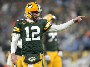 Aaron Rodgers of the Green Bay Packers reacts after throwing a touchdown pass during the third quarter against the Detroit Lions at Lambeau Field on January 08, 2023 in Green Bay, Wisconsin.