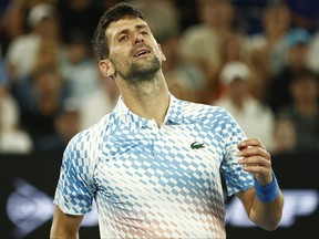 Novak Djokovic of Serbia reacts in the Quarterfinal singles match against Andrey Rublev during day ten of the 2023 Australian Open at Melbourne Park on January 25, 2023 in Melbourne, Australia.