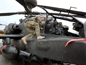 In this image released on January 21, 2013, Prince Harry, makes early morning checks on an Apache helicopter at the British controlled flight-line at Camp Bastion on December 12, 2012 in Afghanistan.  (John Stillwell - WPA Pool/Getty Images)