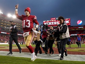 San Francisco 49ers quarterback Brock Purdy gestures as he runs off the field after defeating the Seattle Seahawks.