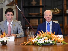 U.S. President Joe Biden (right) and Canadian Prime Minister Justin Trudeau take part in an "emergency" meeting to discuss a missile strike on Polish territory near the border with Ukraine, on the side line of the G20 leaders' summit in Nusa Dua, on the Indonesian resort island of Bali on Nov. 16, 2022.