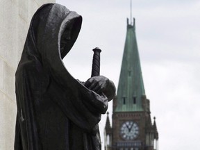 The Peace Tower on Parliament Hill is seen behind the justice statue outside the Supreme Court of Canada in Ottawa, Monday June 6, 2016.