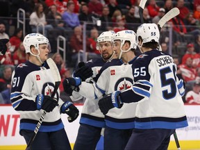 Neal Pionk of the Winnipeg Jets celebrates his first period goal with teammates while playing the Detroit Red Wings at Little Caesars Arena on January 10, 2023 in Detroit, Michigan.
